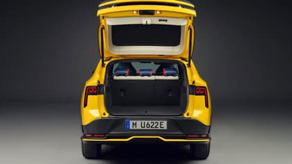 the back of a yellow car with the trunk open