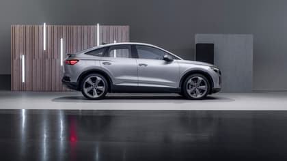 a silver car parked in a showroom