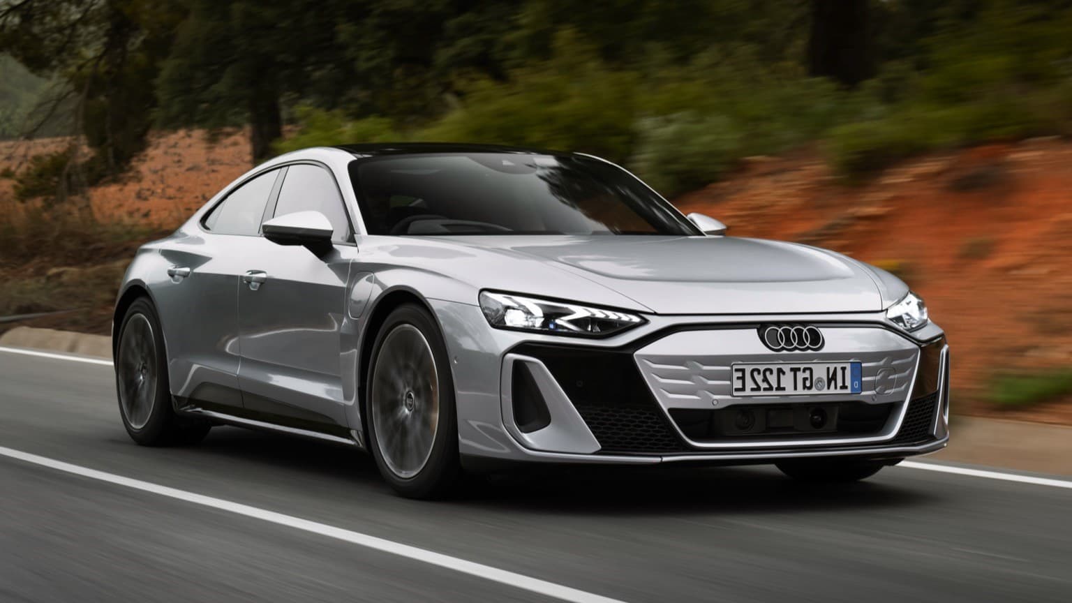 a silver car on a road