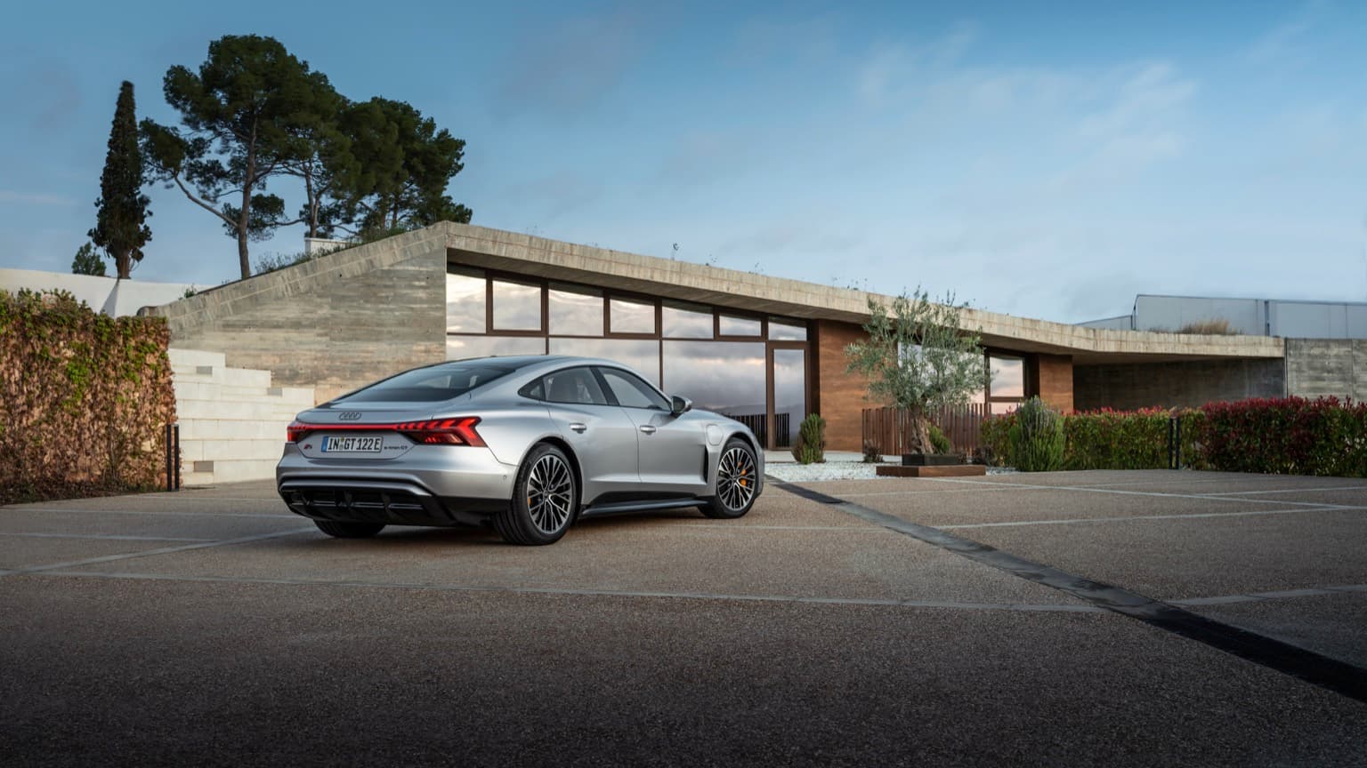 a silver sports car parked in front of a building