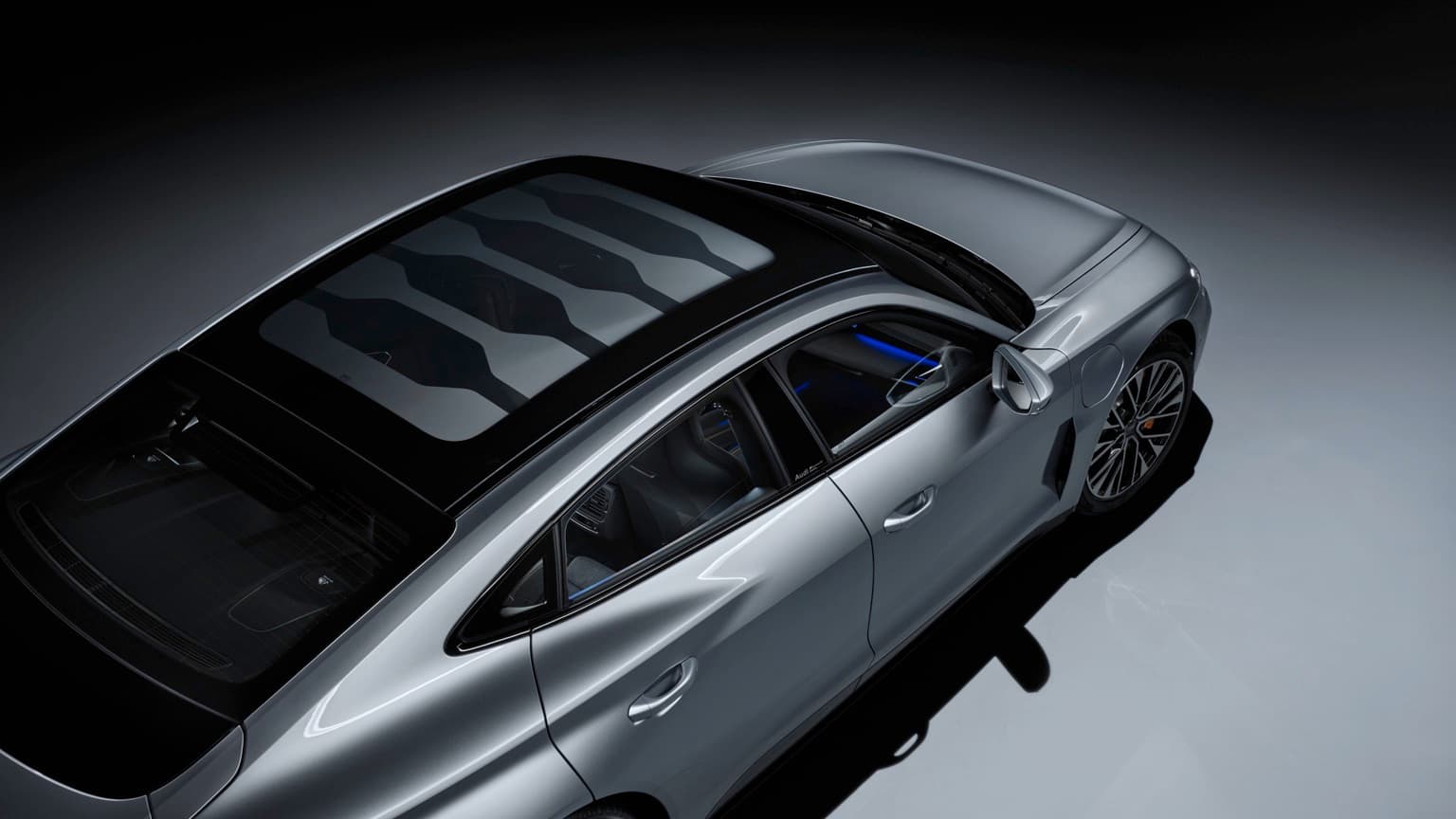 a silver sports car with black roof