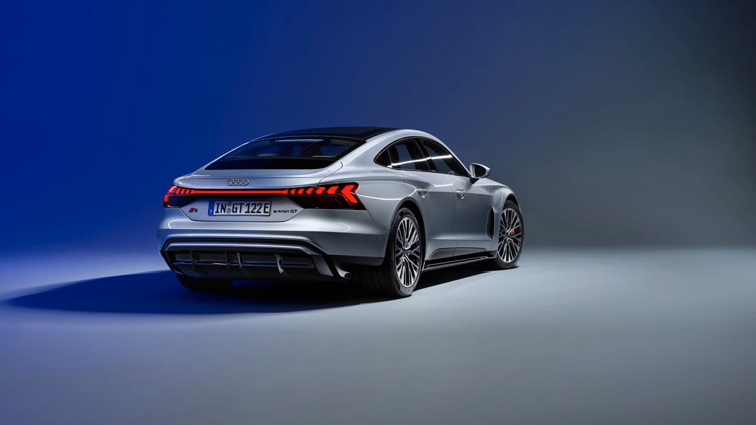 a silver sports car with red lights