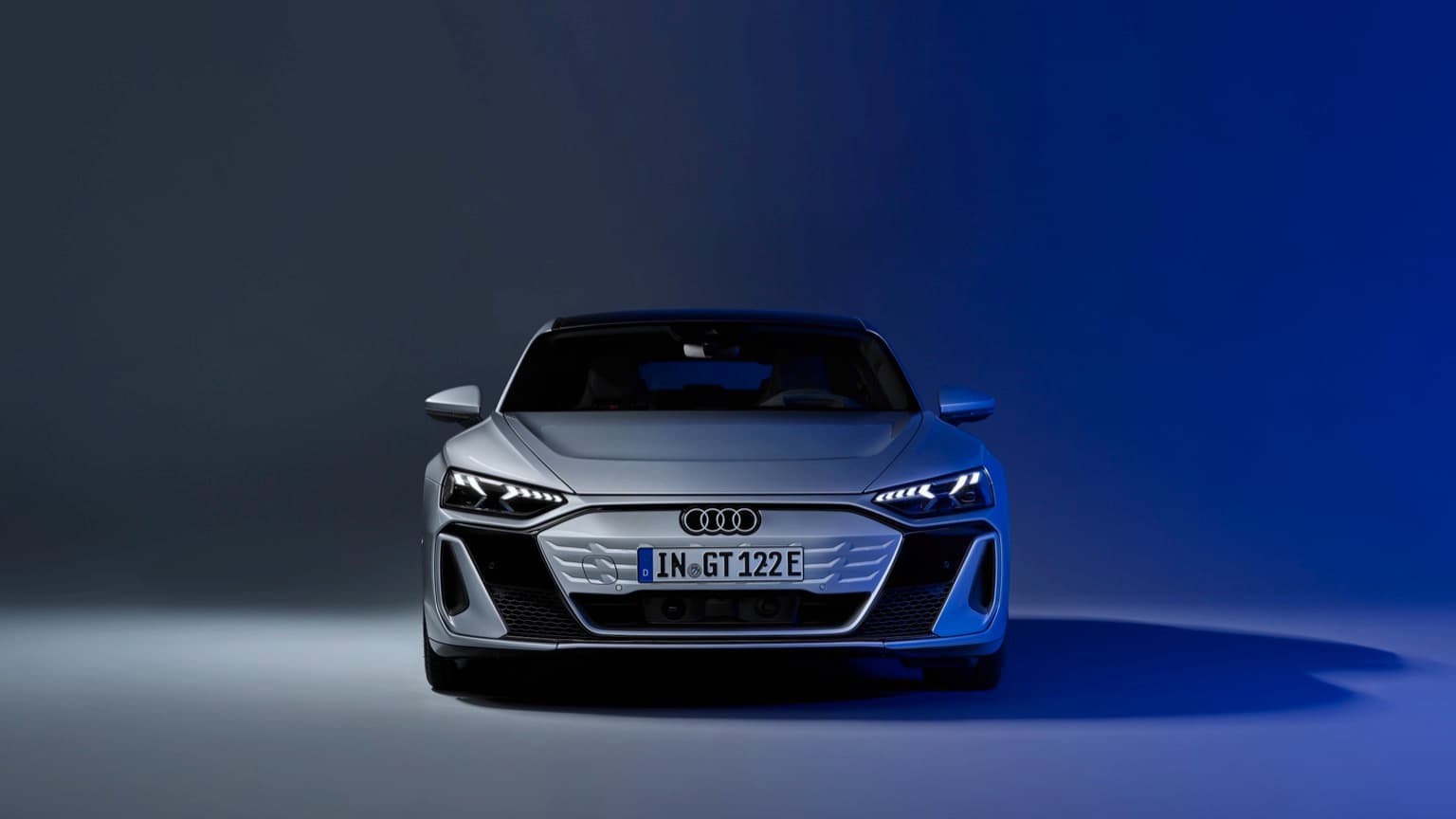 a silver sports car with a blue background