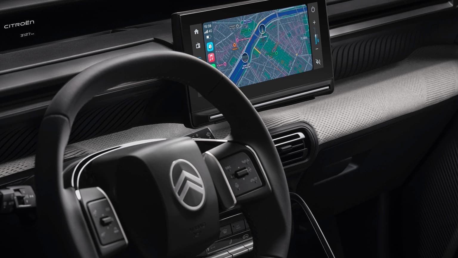 a steering wheel and a screen in a car