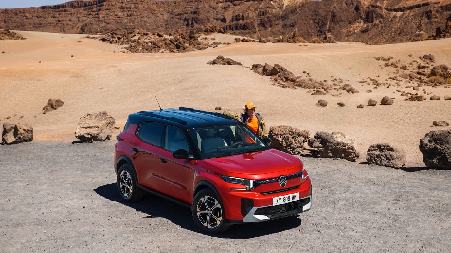 a red car parked in a desert