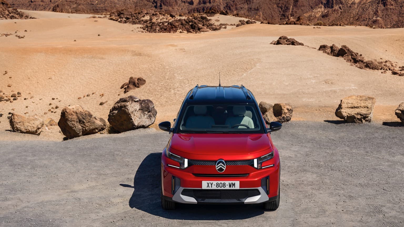 a red car parked in a desert