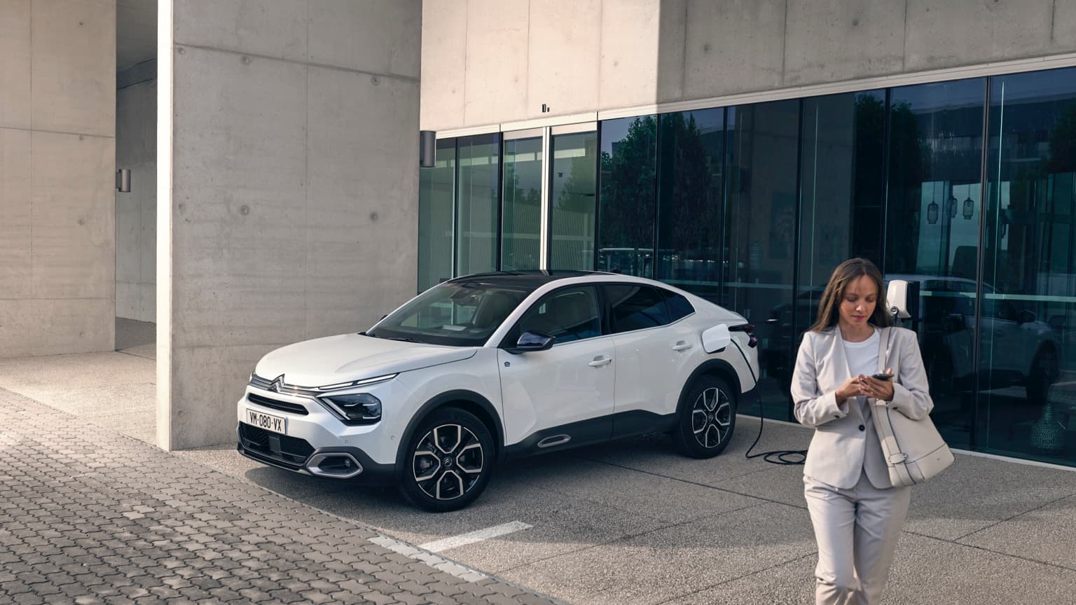 a woman standing next to a car