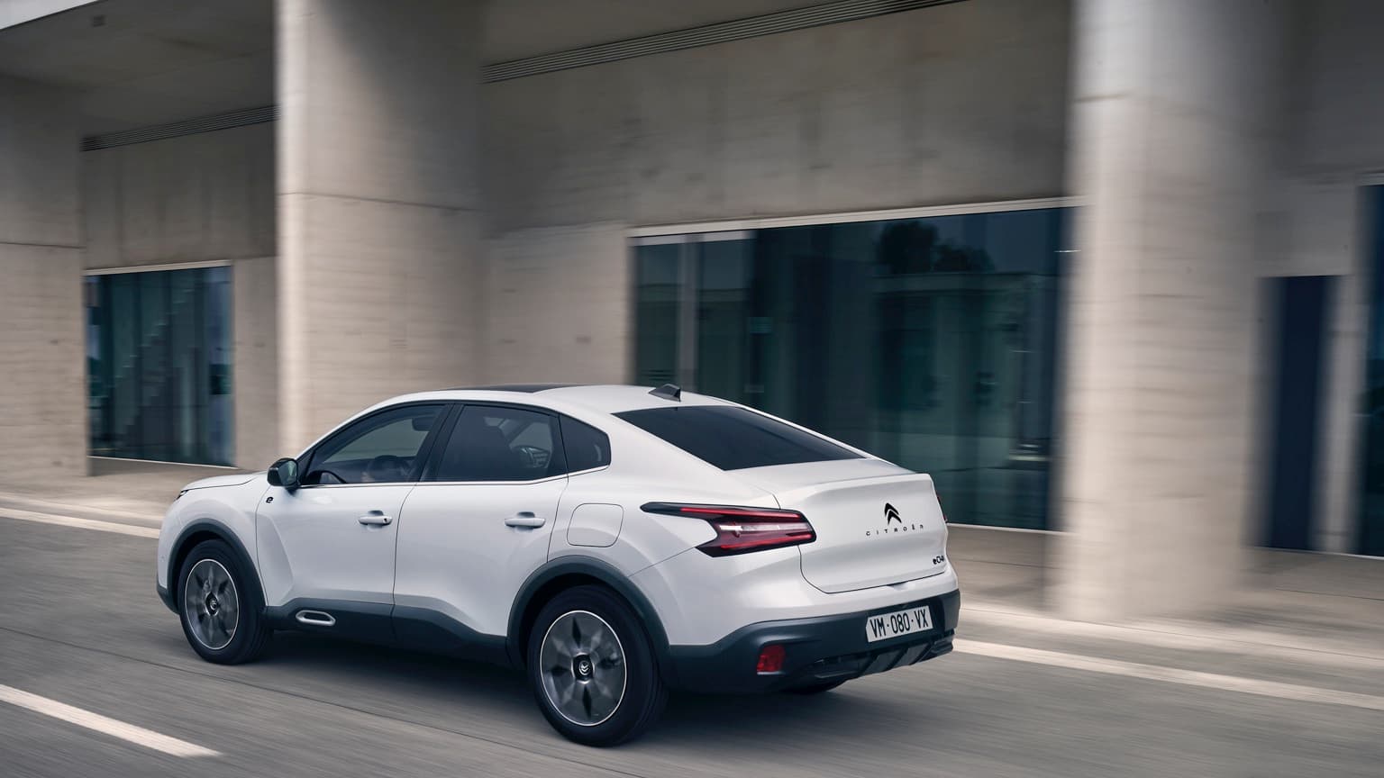 a white car driving on a road