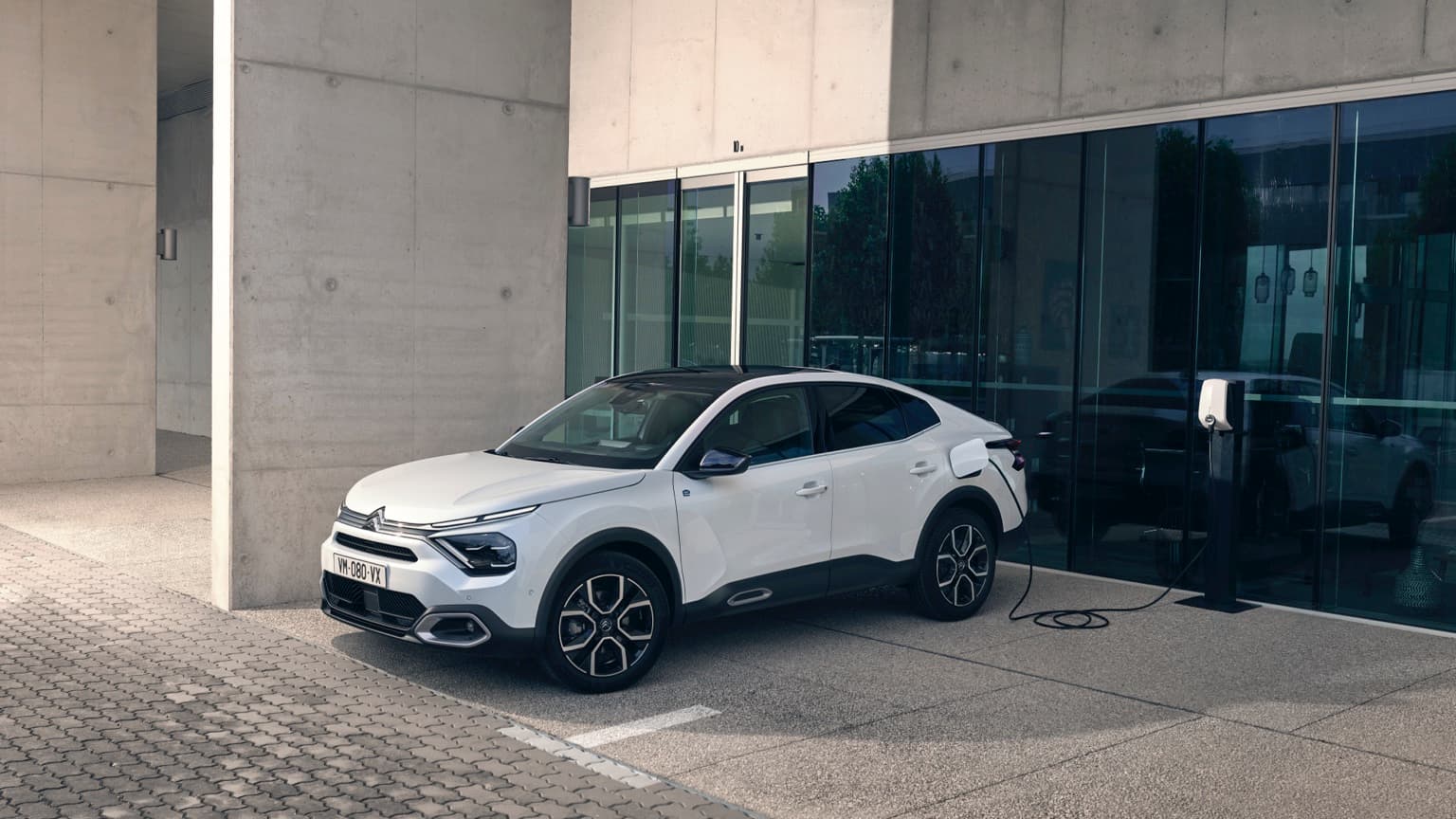 a white car parked in front of a building