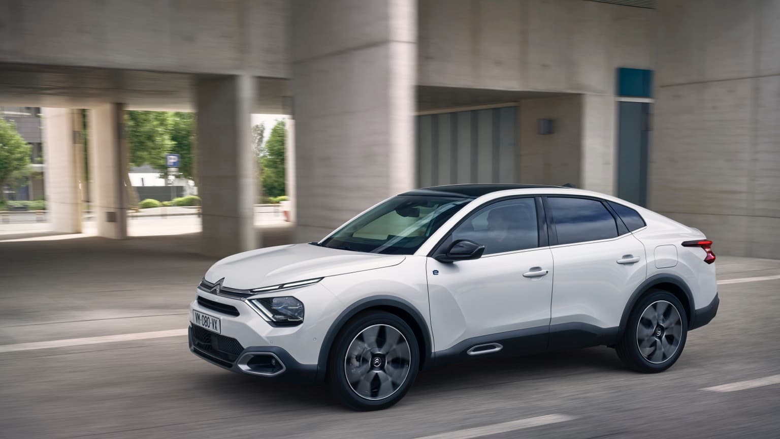 a white car driving on a road