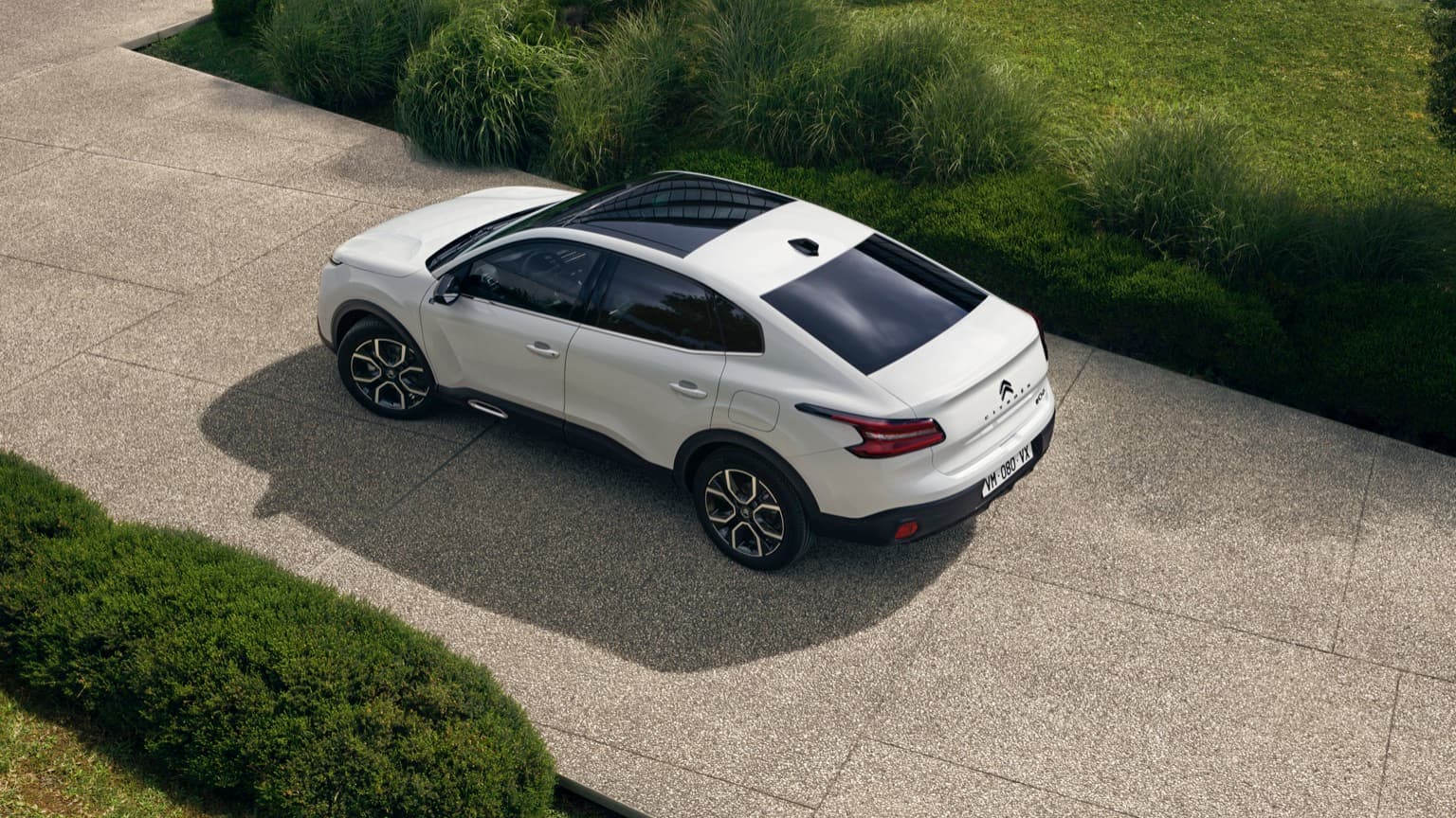 a white car parked on a driveway