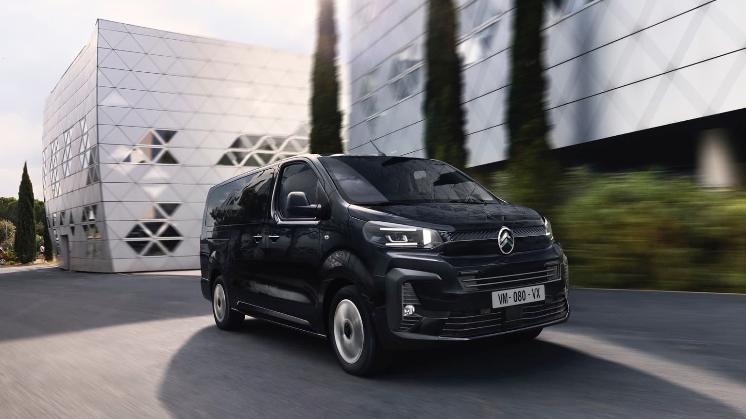 a black van driving on a road