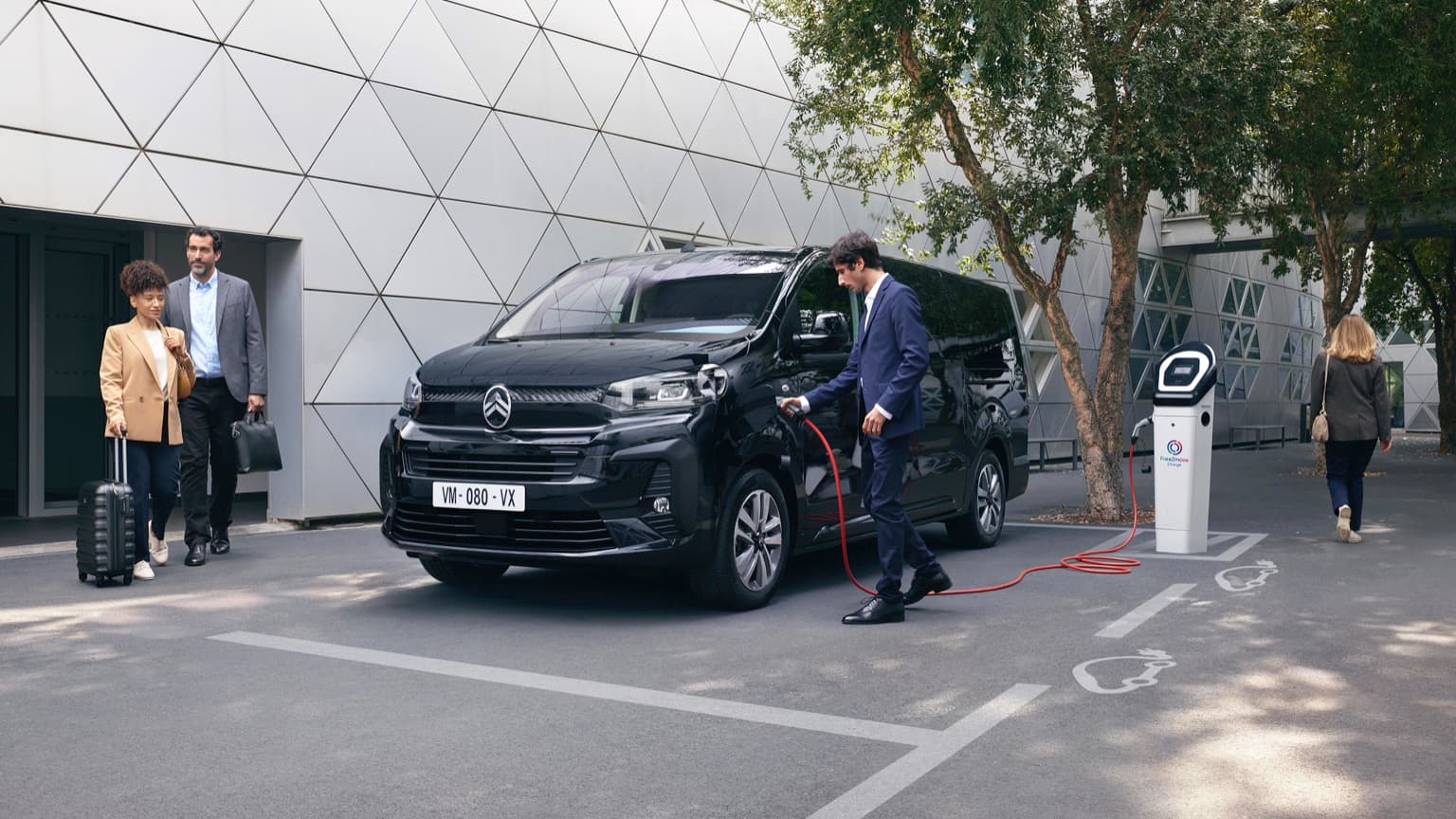 a man charging a car