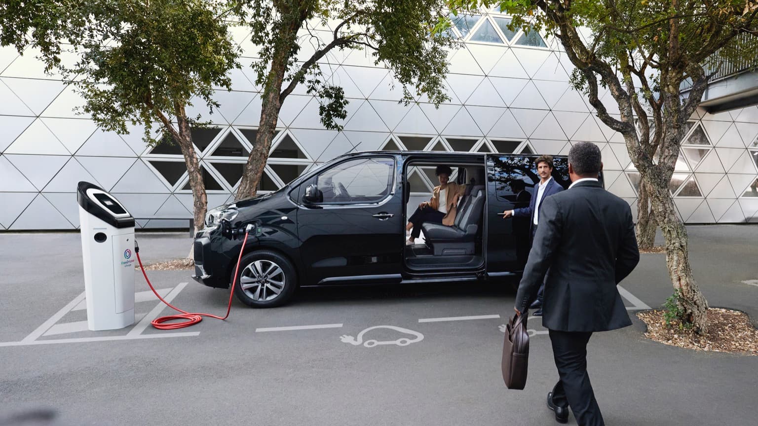 a man in a suit getting into a car