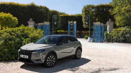 a car parked in front of a gated entrance