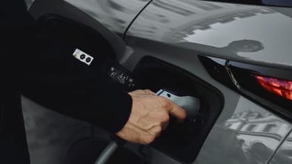 a person holding a gas pump
