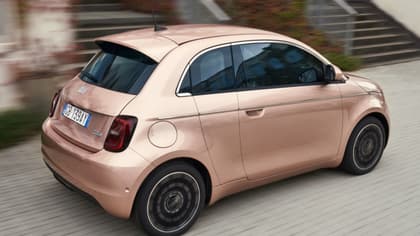 a small pink car on a road