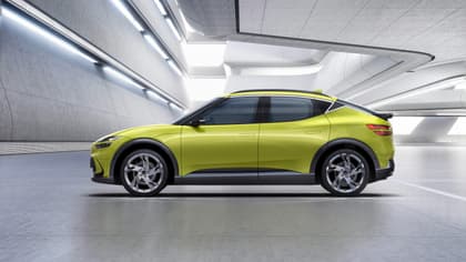 a green car parked inside a building