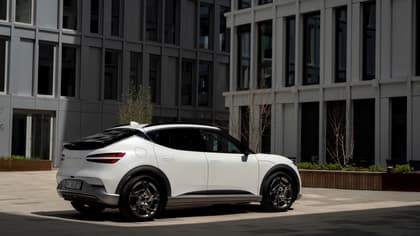 a white car parked in front of a building