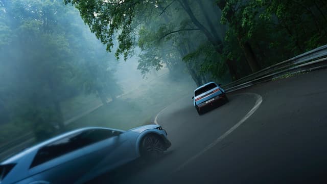 two cars driving on a road