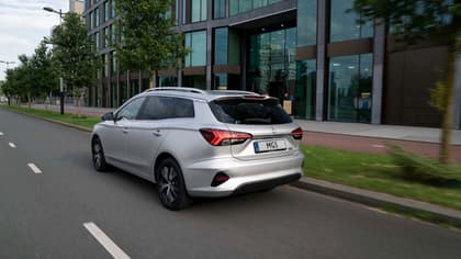 a silver car driving on the road