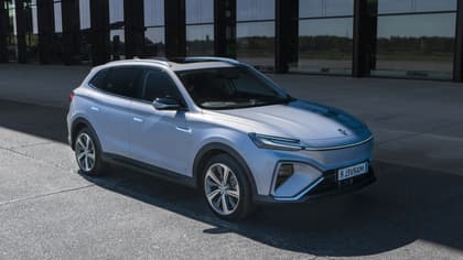 a silver suv parked in front of a building
