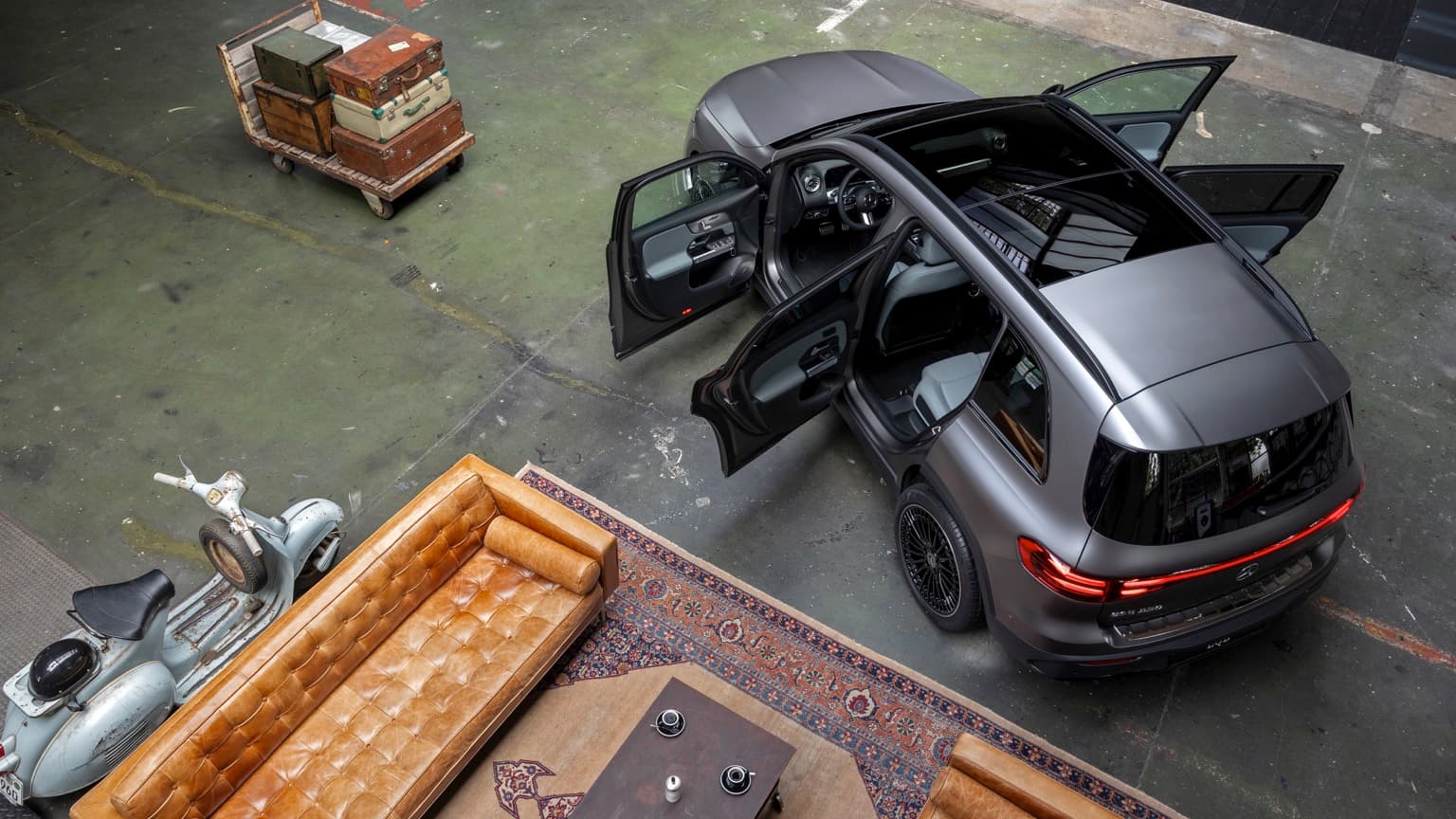 a car with open door and luggage in a garage