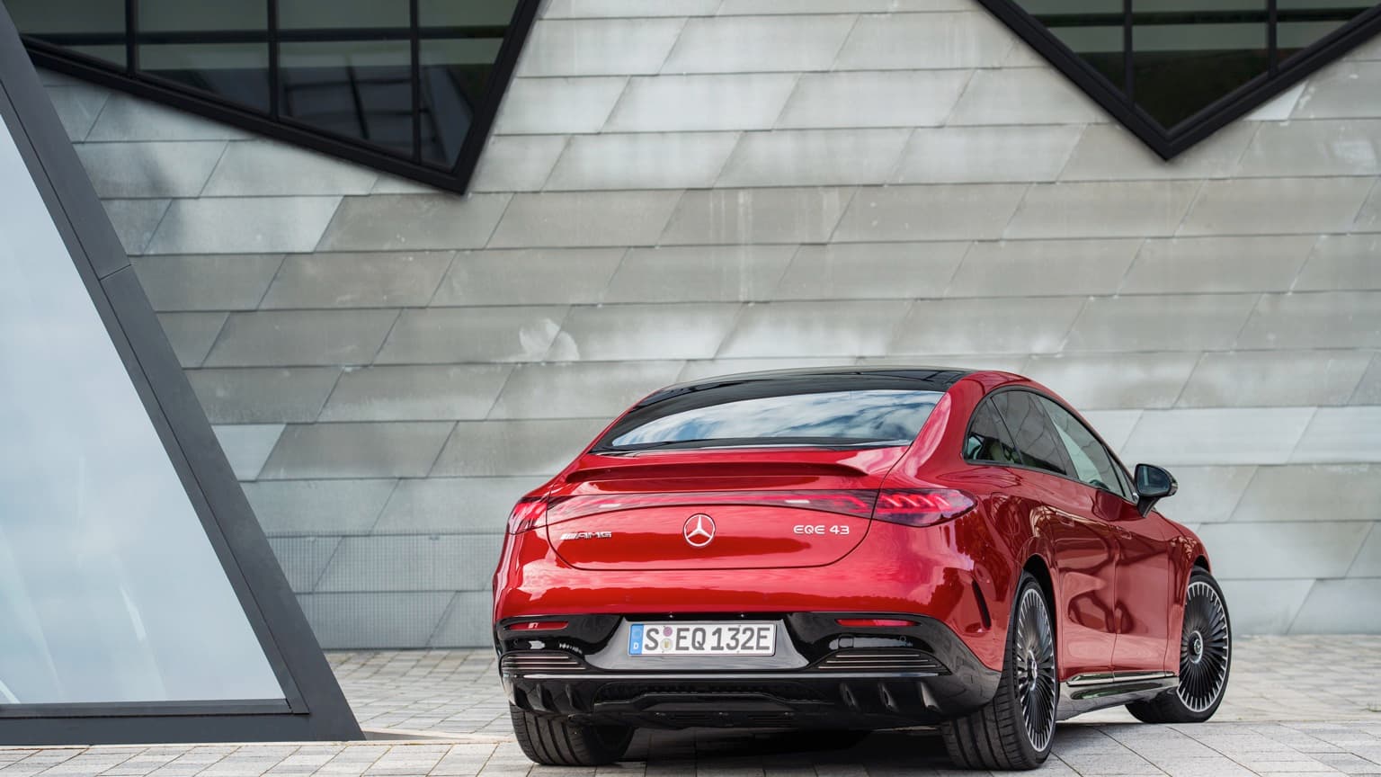 une voiture rouge garée devant un bâtiment