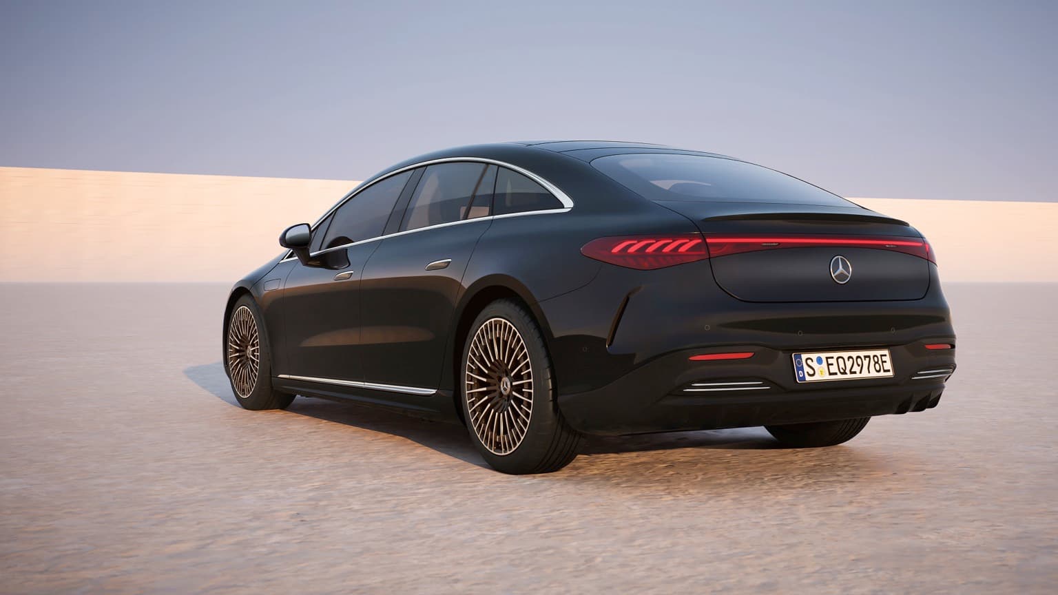 a black car parked on a sandy area