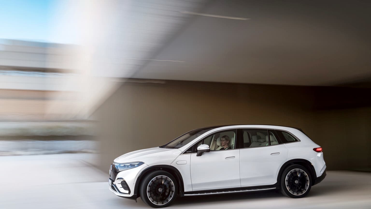 a woman driving a white car