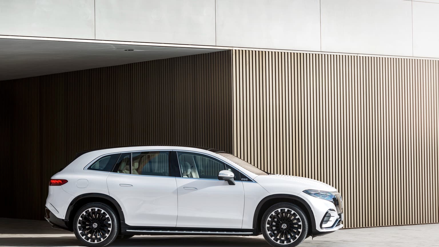 a white car parked in front of a building