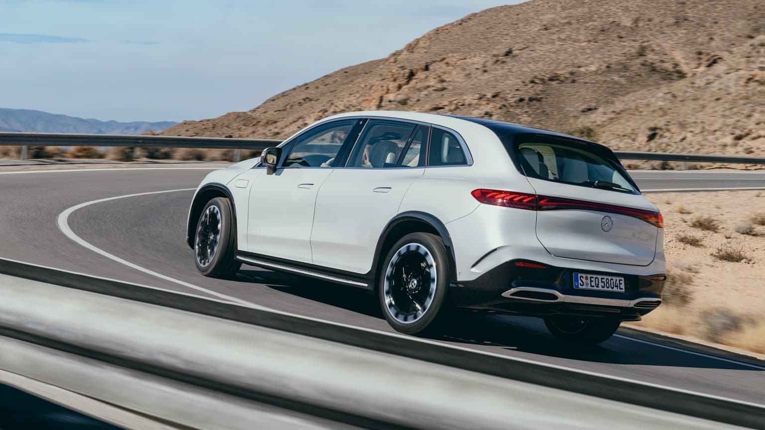 a white car driving on a road