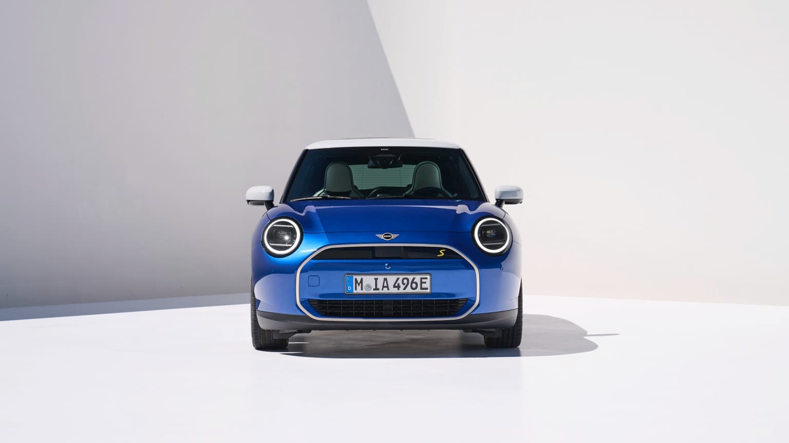 une voiture bleue garée dans une pièce blanche