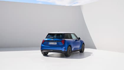 a blue car parked in a white room