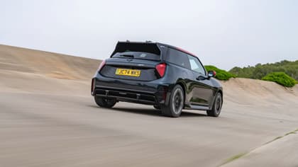 a black car driving on a road