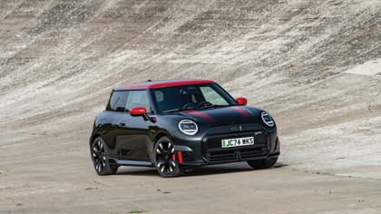 a black and red car parked on a concrete surface