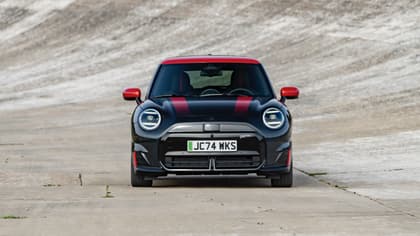 a black and red car on a road