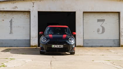 a black and red car with a charging cable