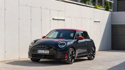 a black and red car parked on a concrete surface