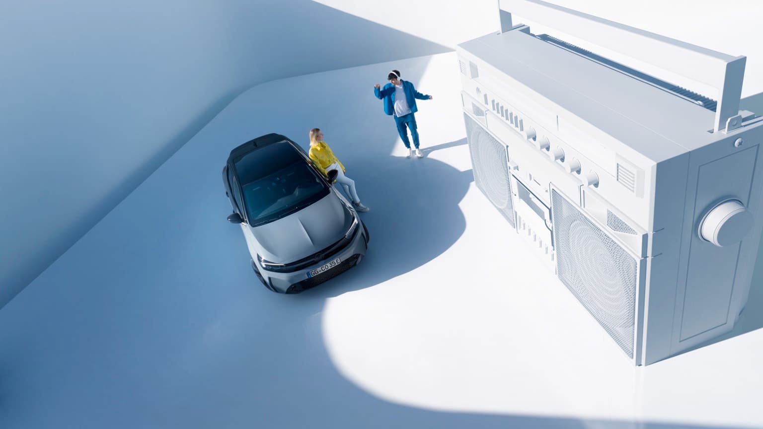 a man and woman standing next to a car