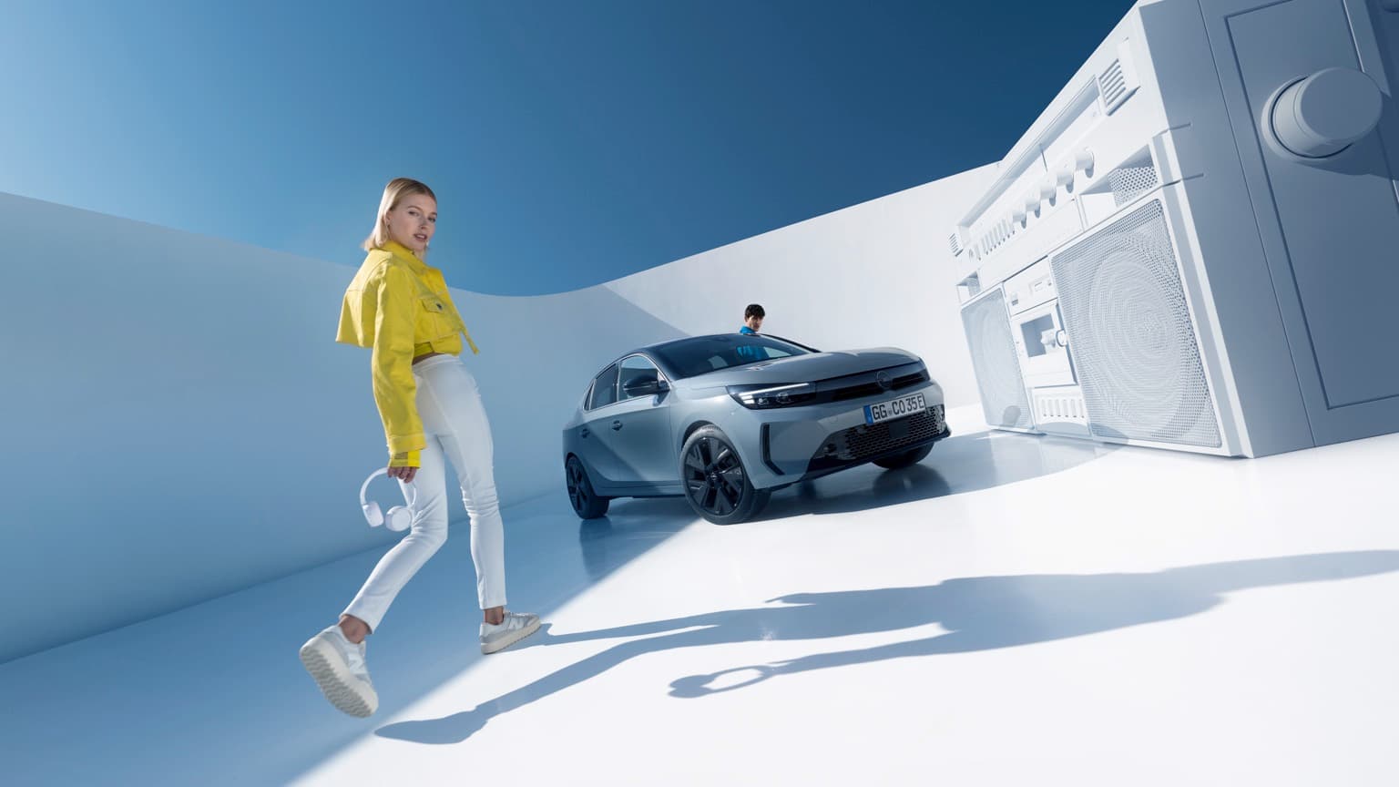 a woman walking in front of a car
