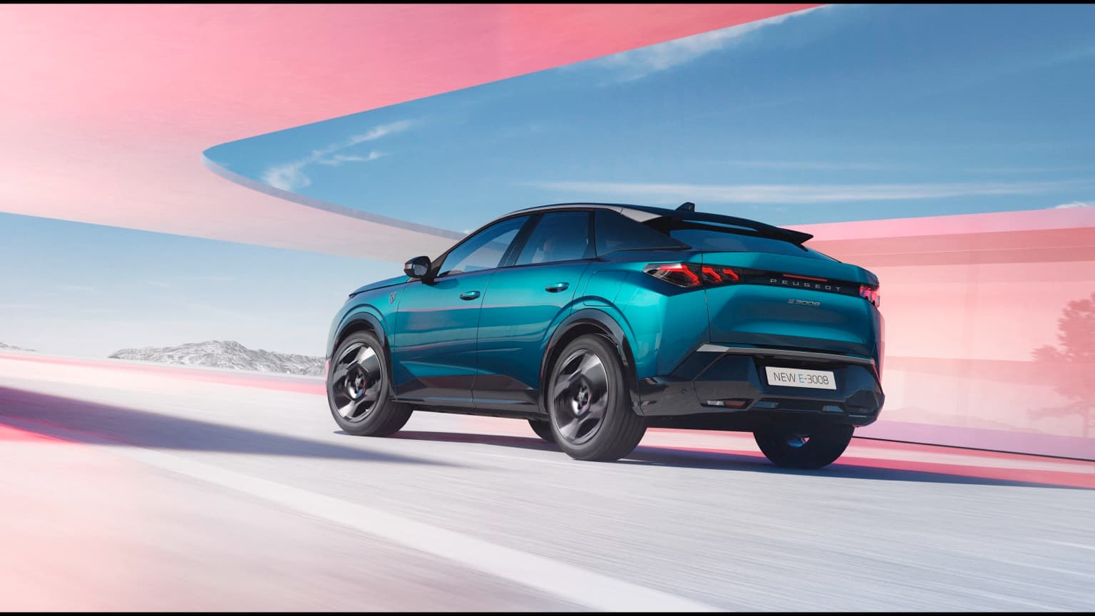 a blue car driving on a road