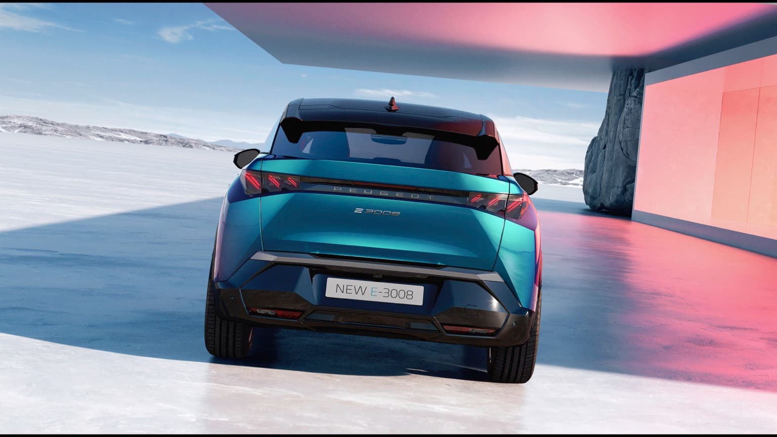a blue and black car on a snowy road