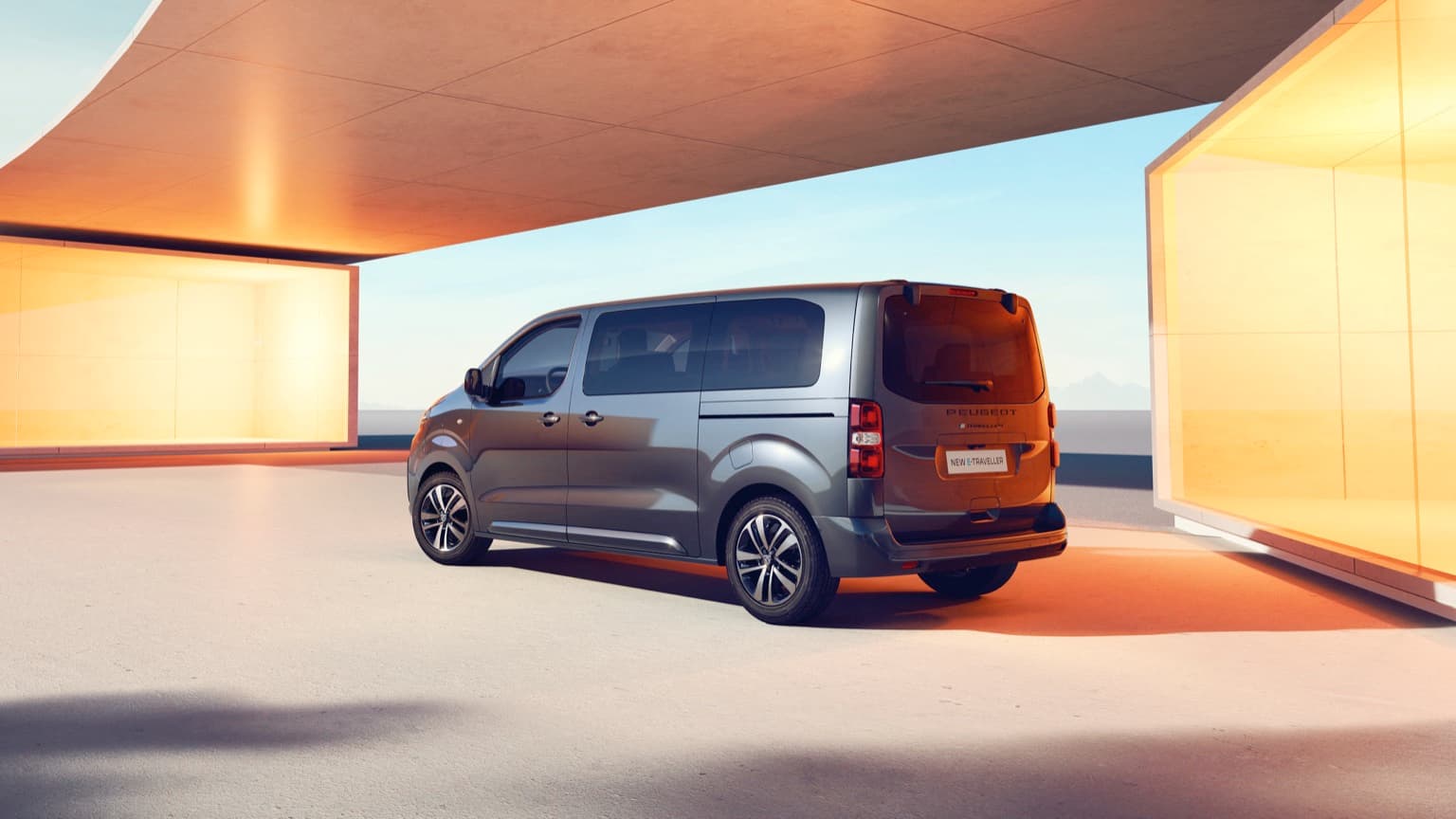 a grey van parked under a roof