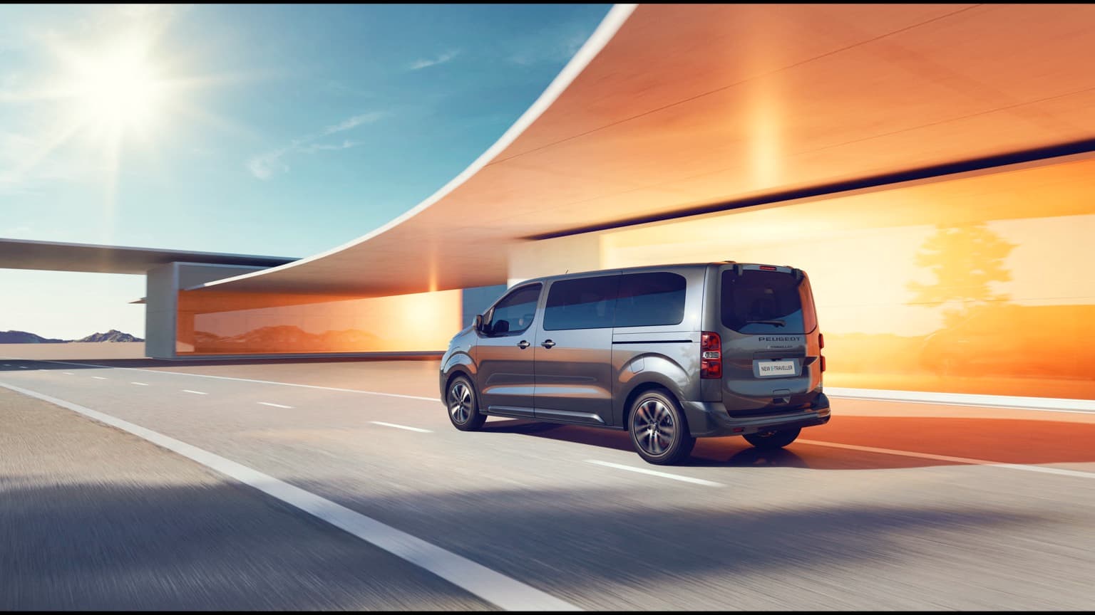 a grey van driving on a road