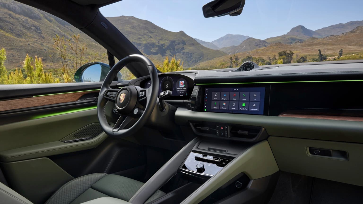 the inside of a car with a view of mountains and trees