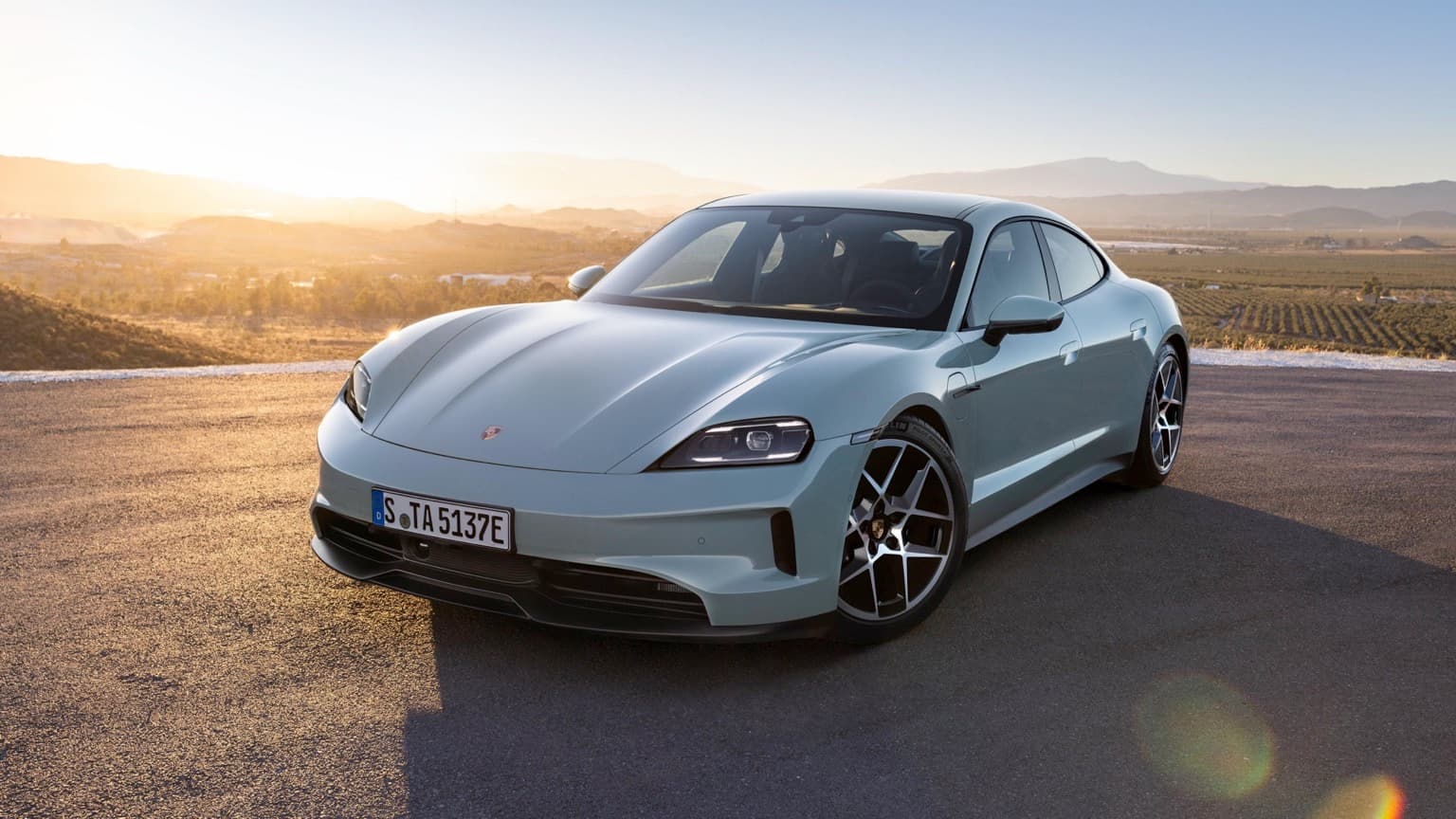 a silver sports car parked on a road