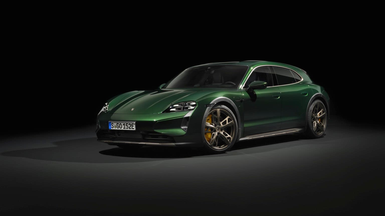 a green sports car with a black background