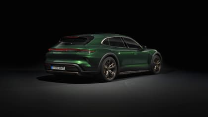 a green sports car in a dark room
