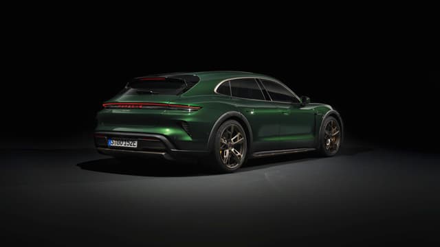 a green sports car in a dark room